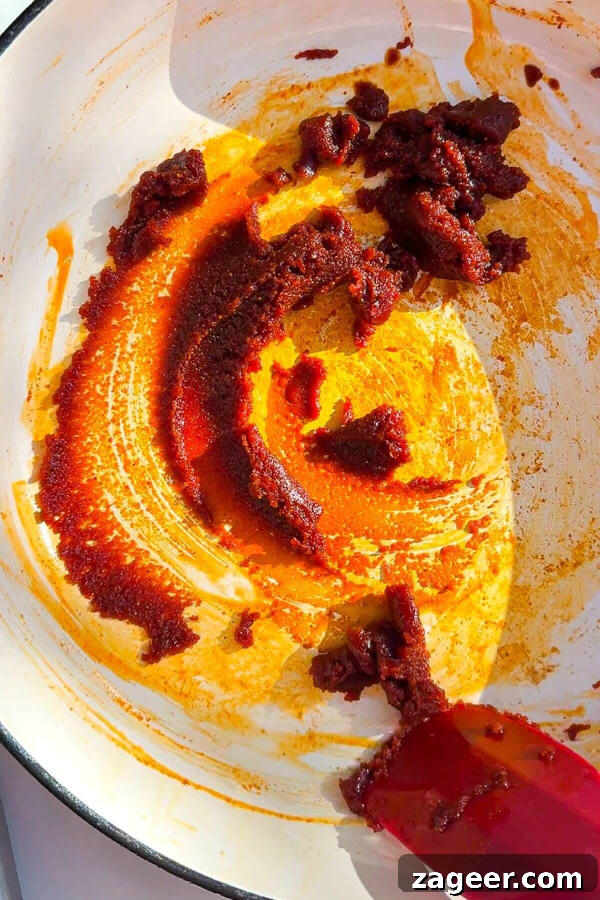 Velvety One-Pot Coconut Butternut Ramen 6 Stirring gochujang paste and peanut butter in a pan.
