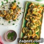 Pesto ricotta puff pastry cups laid out on serving plates.