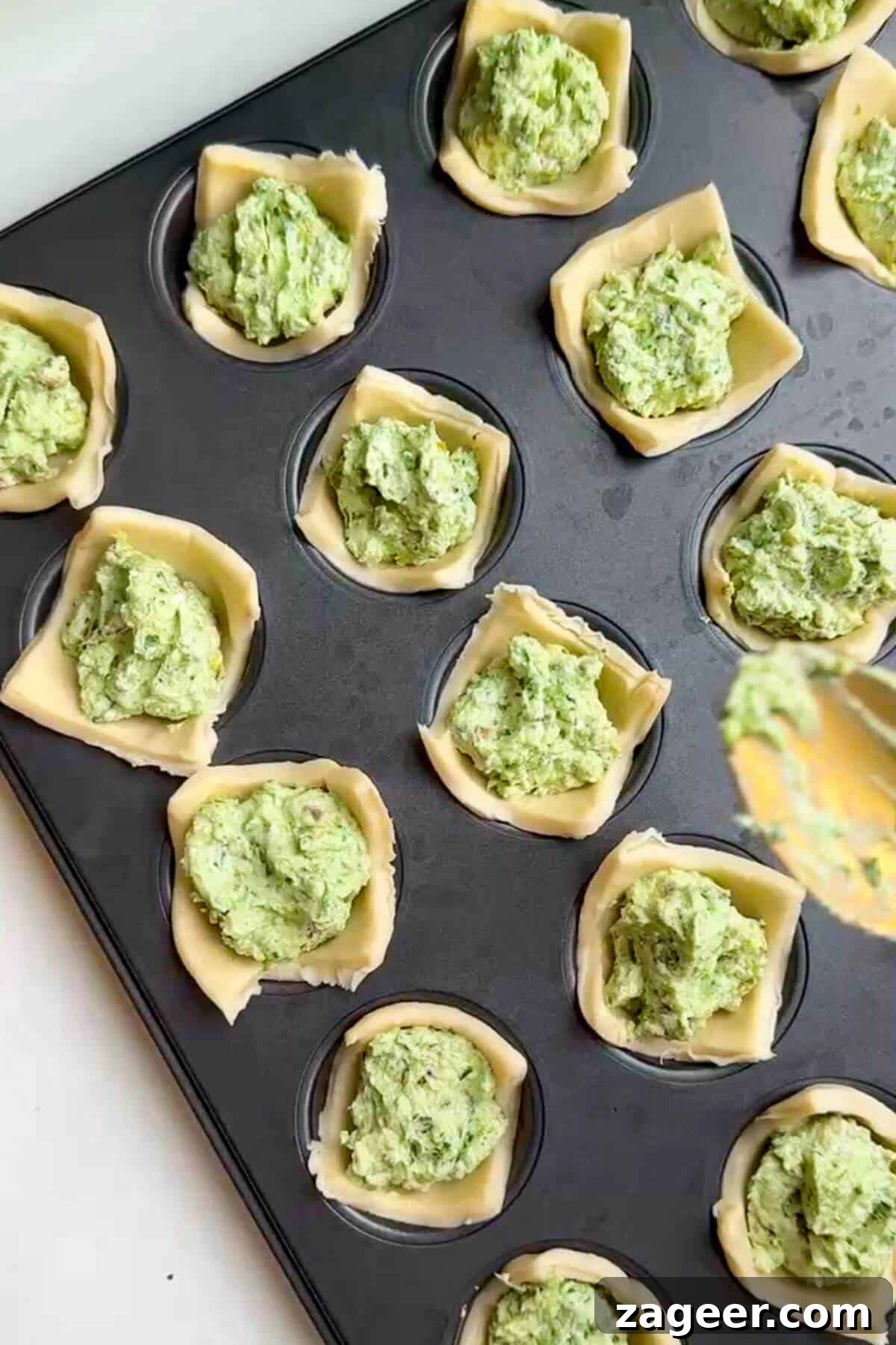 Savory Pesto Ricotta Puff Pastry Bites 7 Pesto ricotta filling spooned into puff pastry cups.