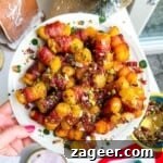 Bacon wrapped tater tots drizzled with honey and nuts on a plate.