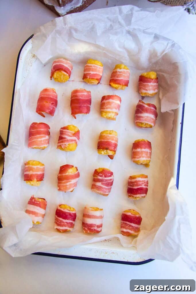 Easy Bacon Wrapped Tots Air Fryer Oven 4 Bacon wrapped around tater tots in an oven dish.