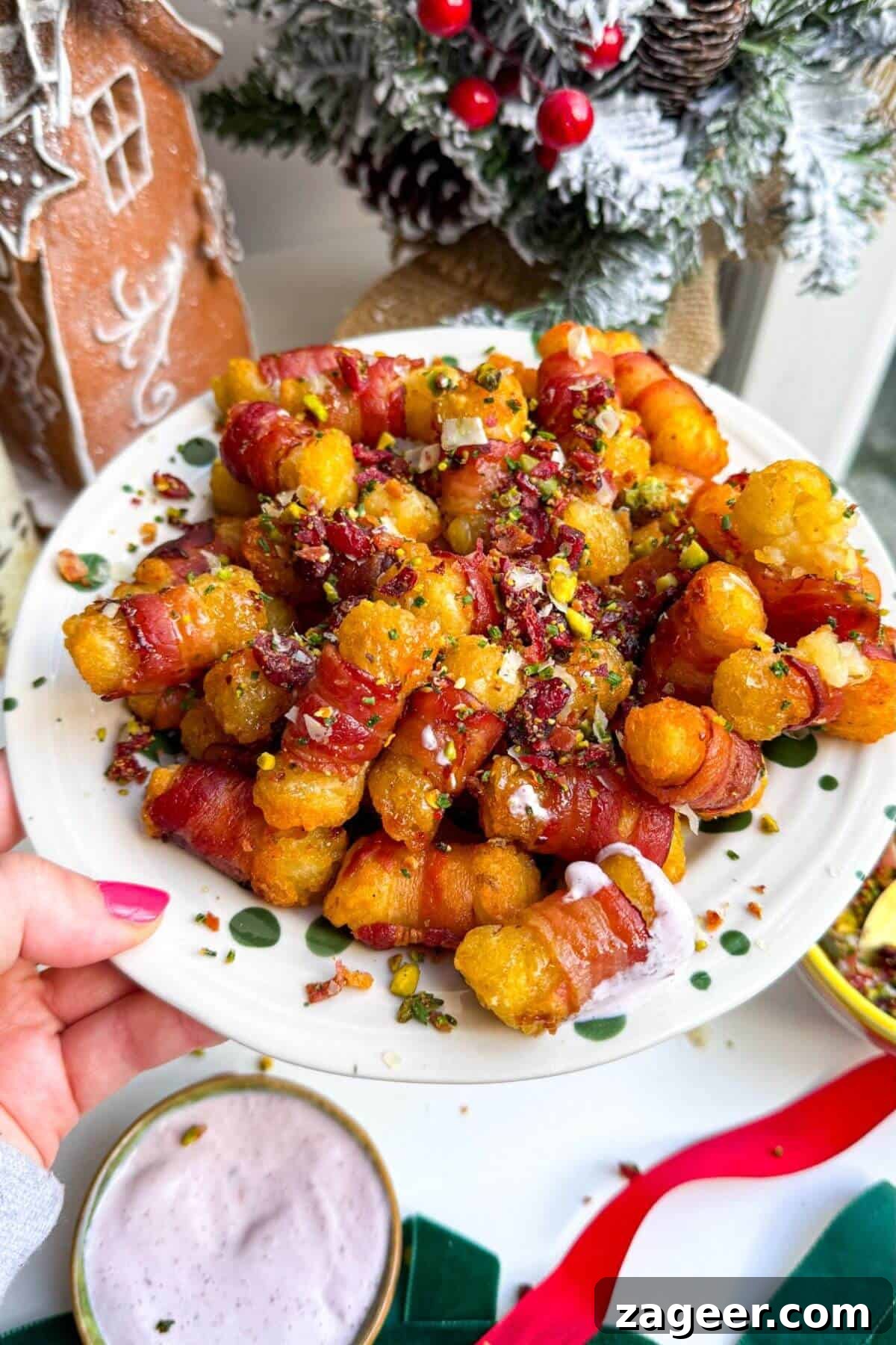 Easy Bacon Wrapped Tots Air Fryer Oven 6 Bacon wrapped tater tots drizzled with honey and nuts on a plate.