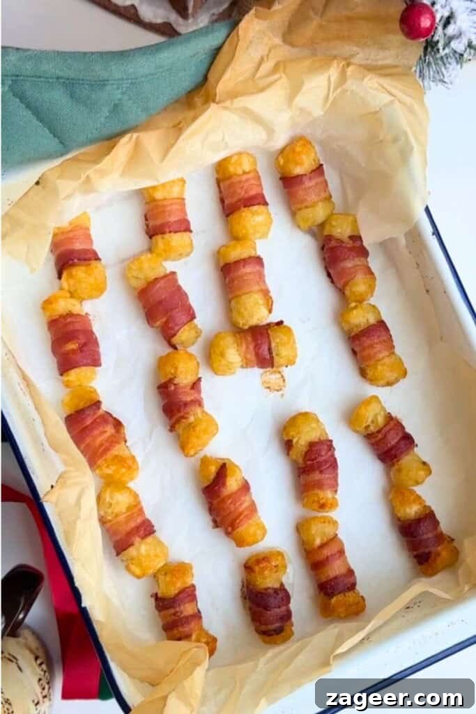 Easy Bacon Wrapped Tots Air Fryer Oven 8 Baked bacon wrapped tots in oven tray.