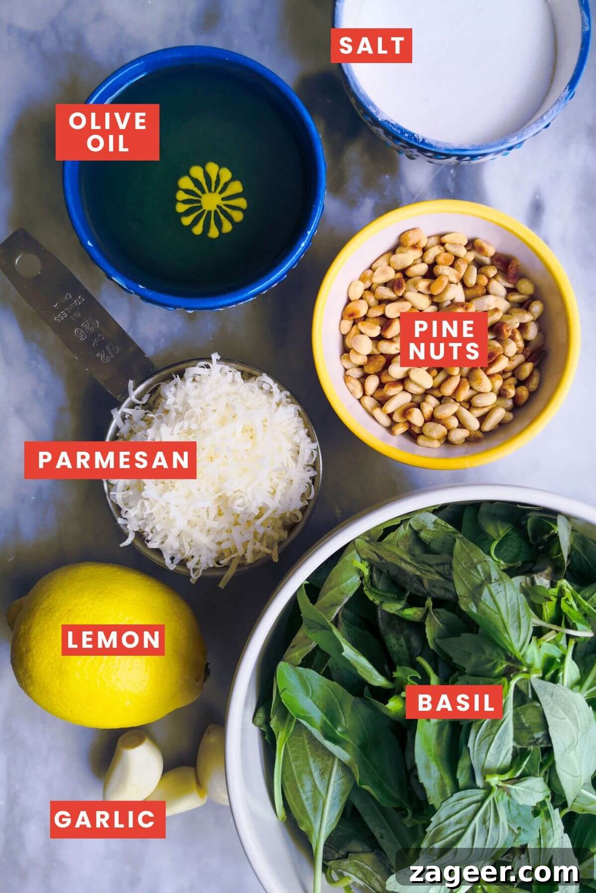 Homemade Basil Pesto So Good So Fast 3 Ingredients for basil pesto laid out on a grey marble background and labelled.
