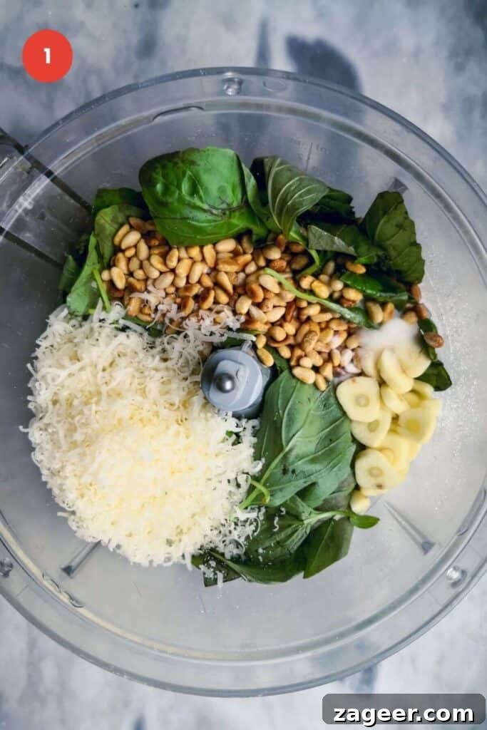 Homemade Basil Pesto So Good So Fast 4 Ingredients for basil pesto in the bowl of a food processor.