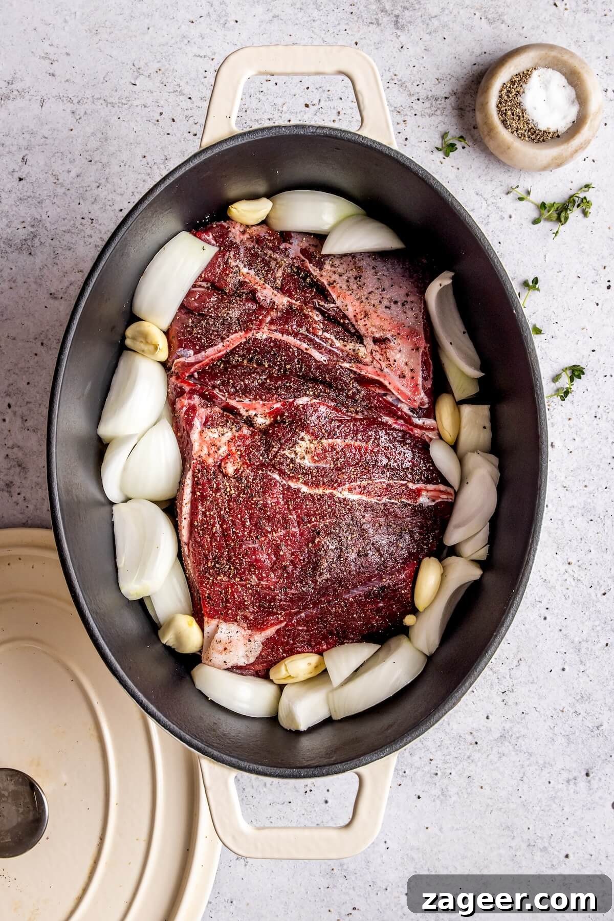 Tender Chuck Roast with Savory Au Jus 9 Chuck Roast in Baking Dish with Onions and Garlic