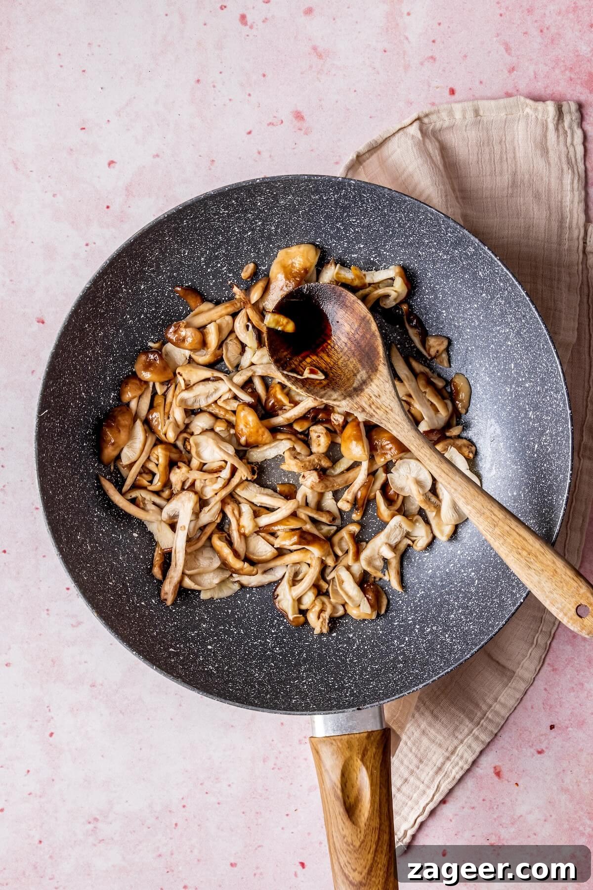 Korean Glass Noodles: A Stir-Fry Sensation 11 Adding tamari to mushrooms in the skillet