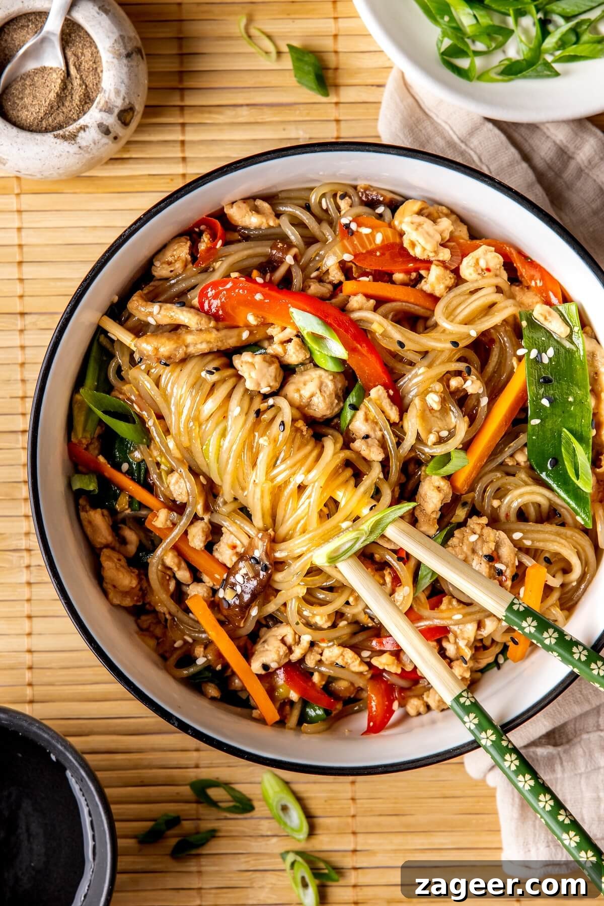 Korean Glass Noodles: A Stir-Fry Sensation 9 A bowl of Korean Glass Noodle Stir Fry with garnishes