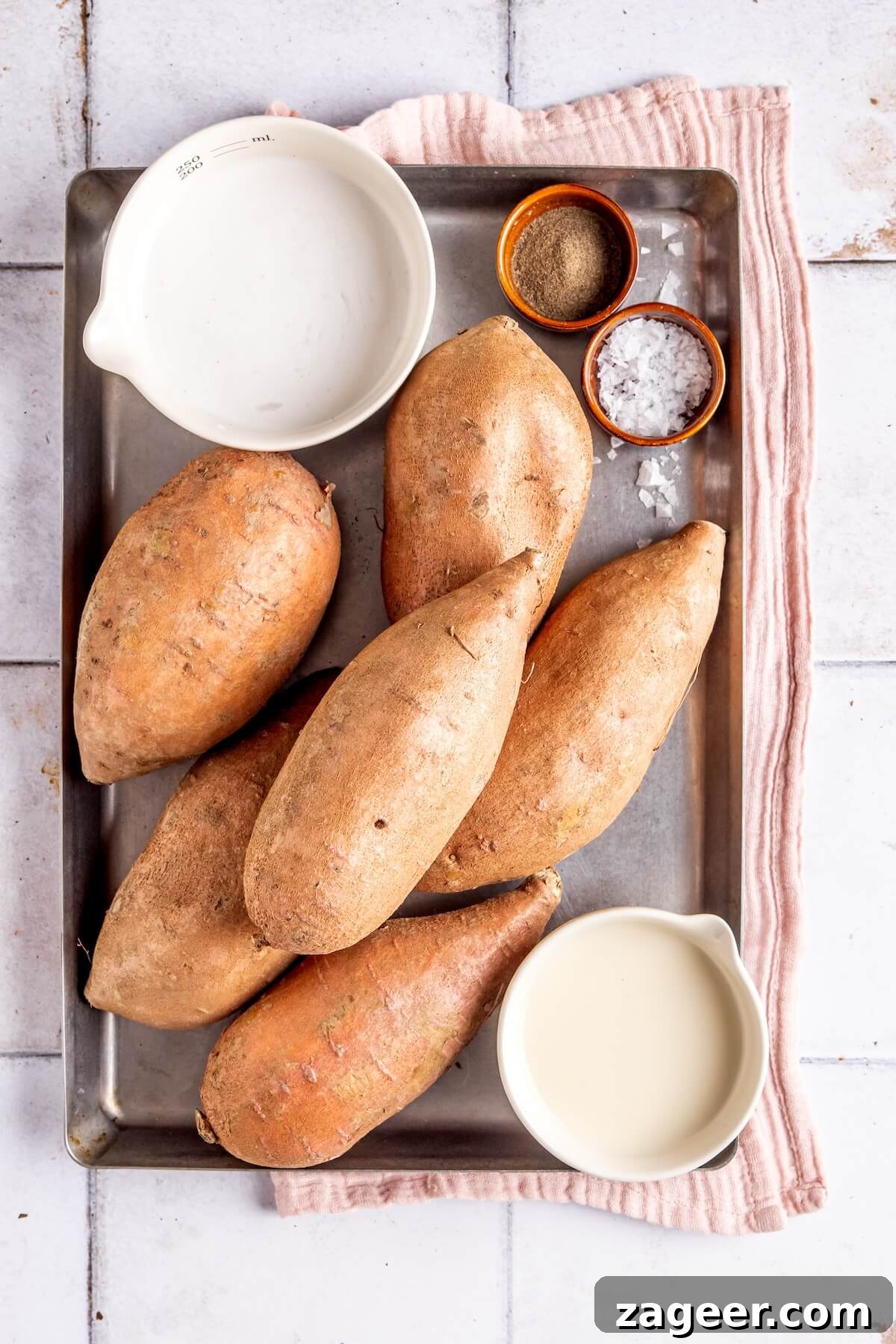Key ingredients for making creamy dairy-free mashed sweet potatoes: sweet potatoes, coconut cream, and almond milk laid out