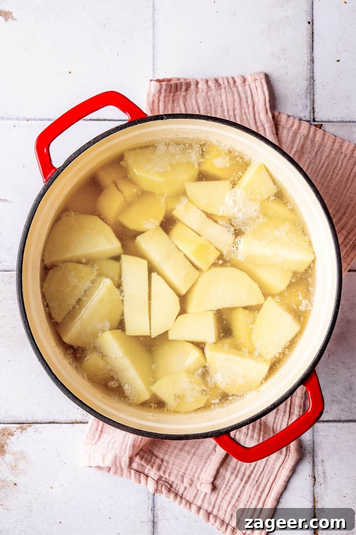 Cubed sweet potatoes covered with water in a large pot, ready for boiling