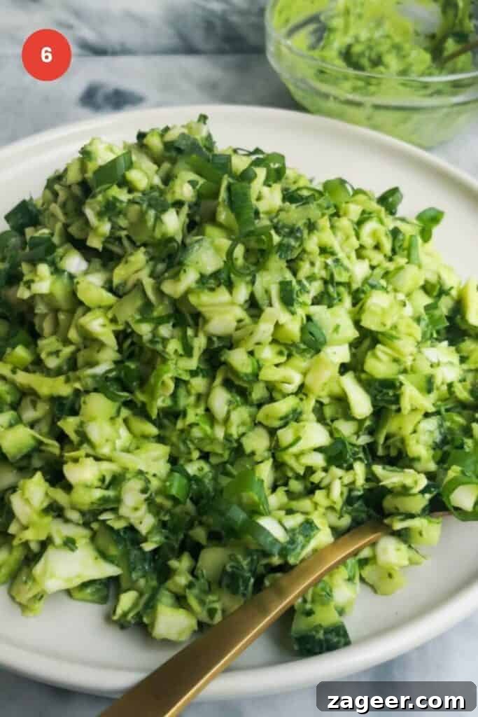 Emerald Goddess Chopped Salad Craze 10 Green goddess salad on a plate with serving spoon.