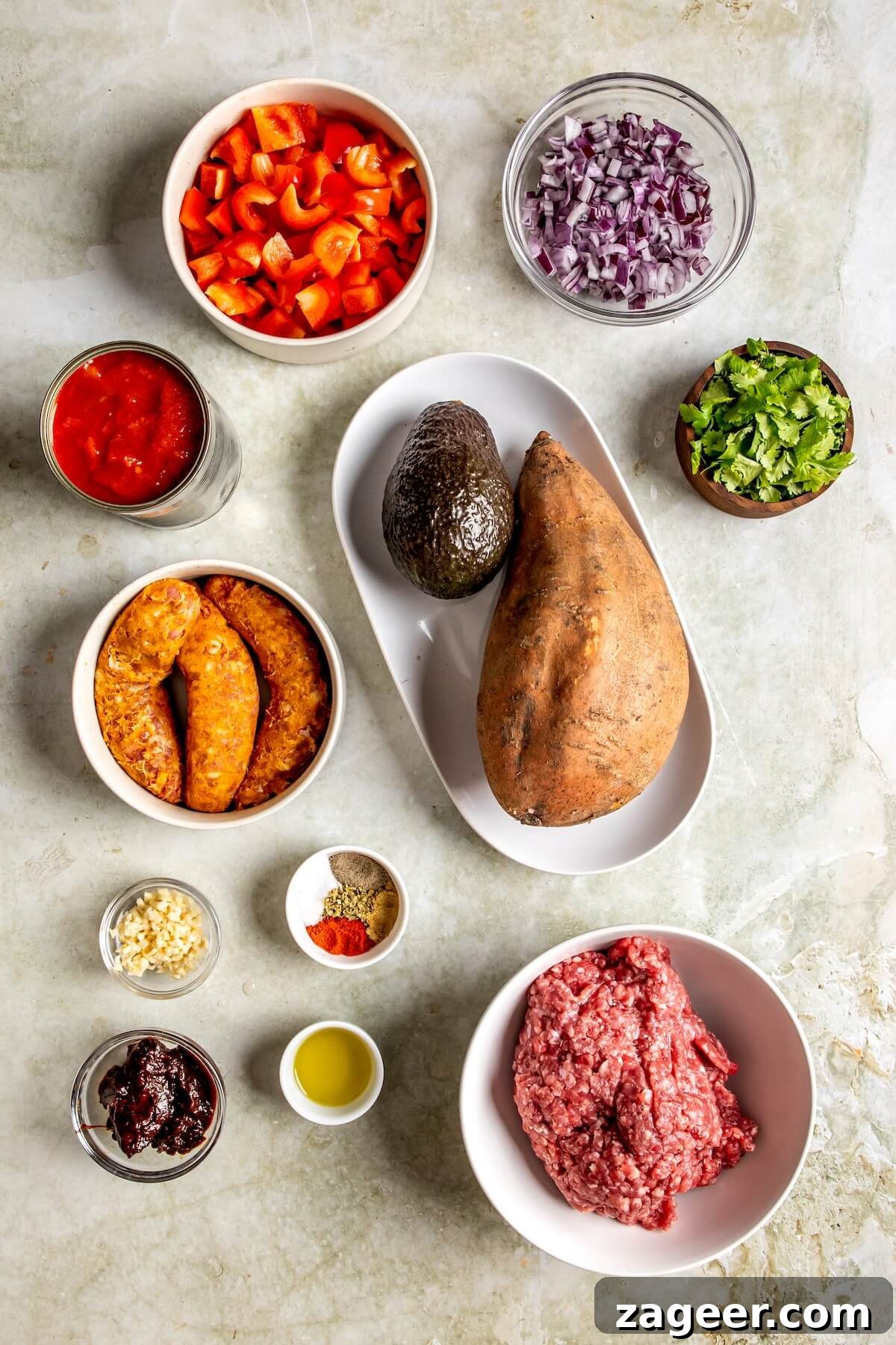 Loaded Chipotle Chorizo Sweet Potatoes 5 A selection of fresh ingredients including sweet potatoes, bell peppers, onions, and spices for the stuffed potato recipe.