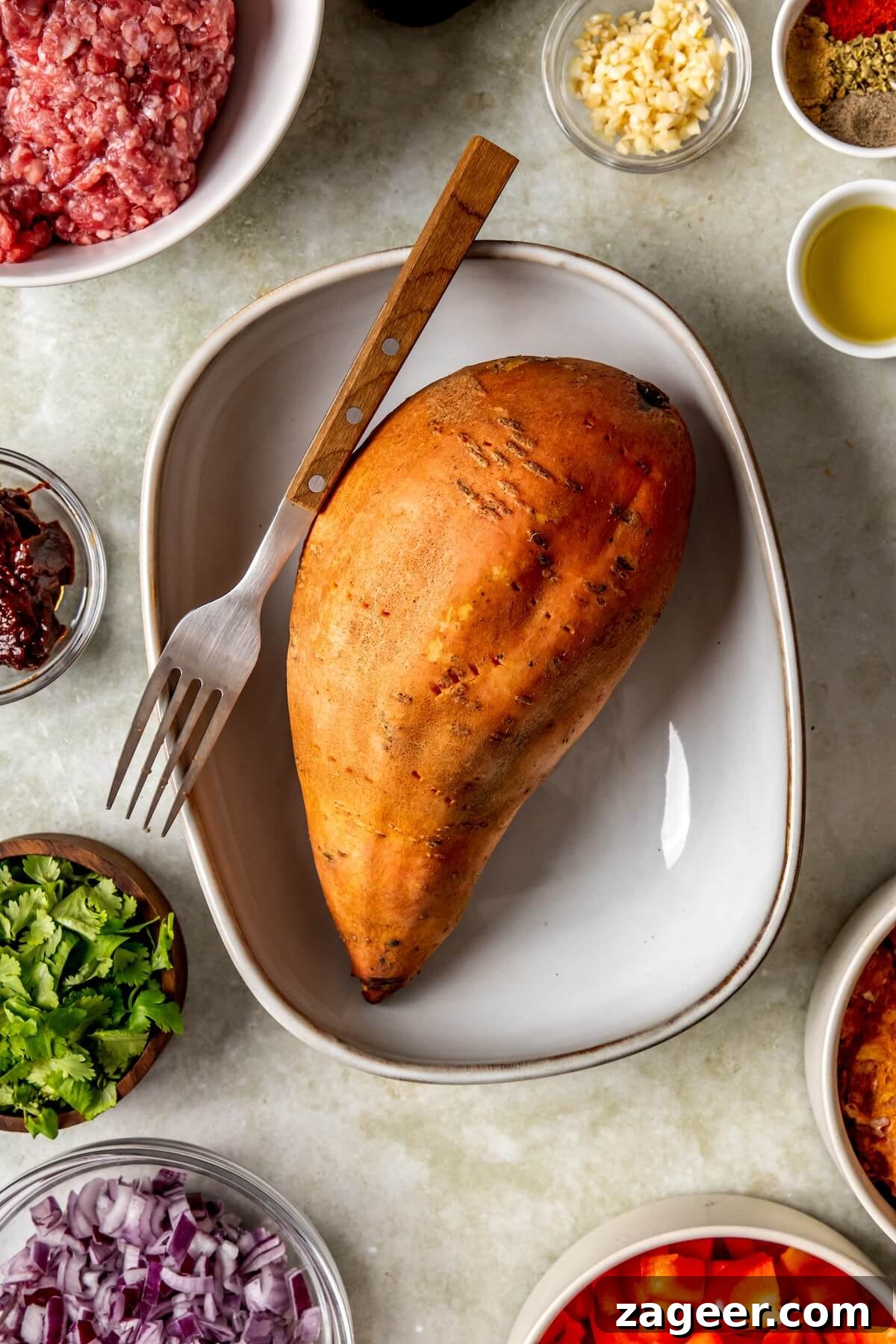 Loaded Chipotle Chorizo Sweet Potatoes 8 Step 1: Sweet potatoes pierced and ready for baking in a simple dish.