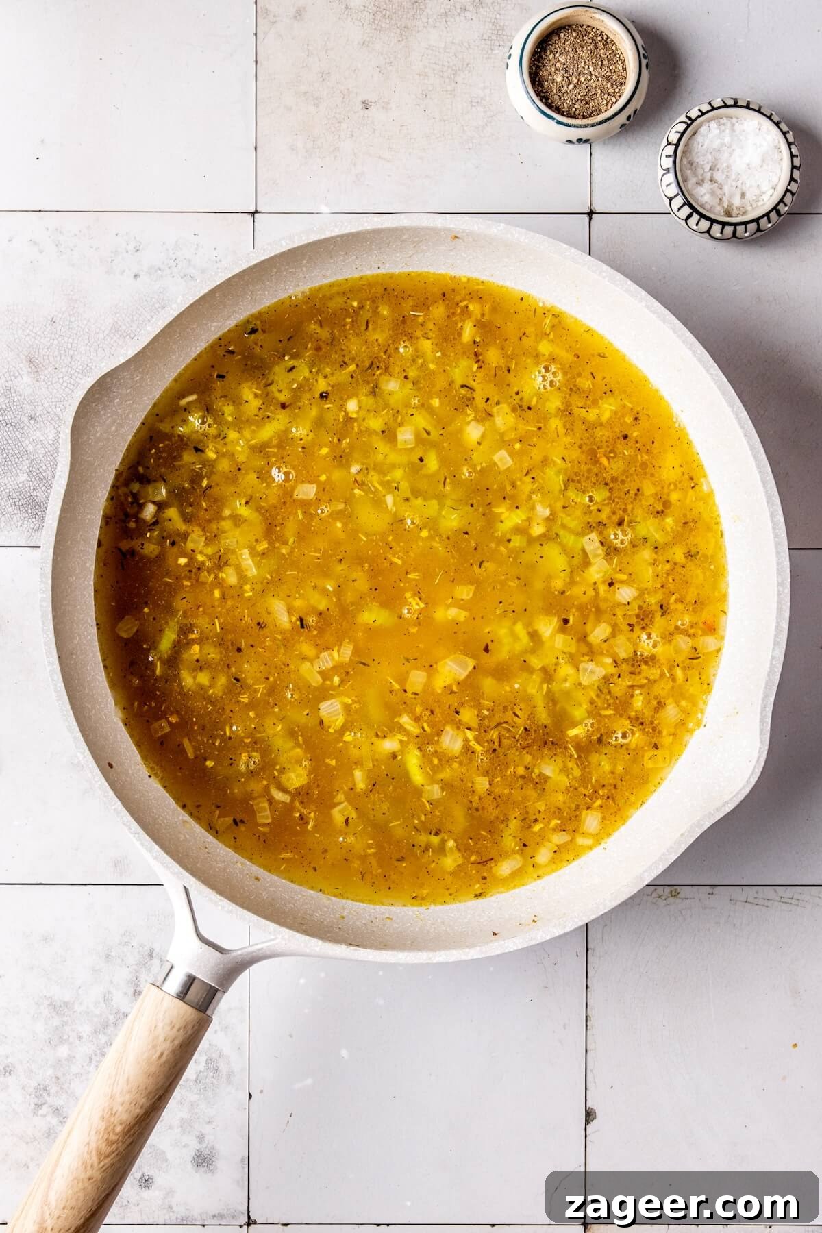 Adding turkey stock to the stuffing mixture