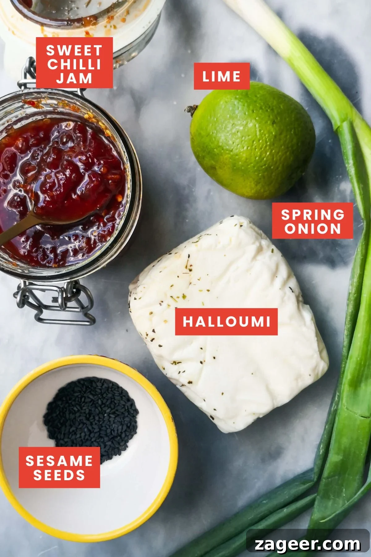 Sticky Sweet Chili Halloumi 3 Ingredients for sweet chilli halloumi on a grey marble background, including halloumi, chilli jam, and fresh limes, ready for preparation.
