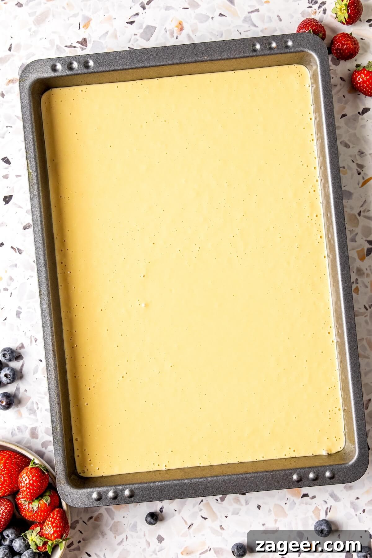 Gluten Free Sheet Pan Pancake Bake 9 Baked gluten-free sheet pan pancakes cooling on the pan, ready to be sliced.