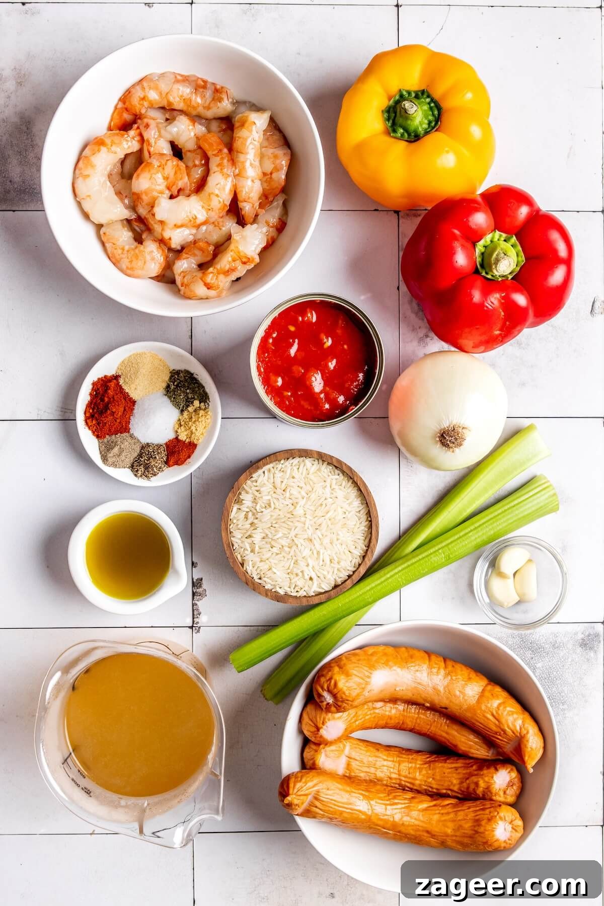 Assortment of fresh ingredients for One Pot Cajun Shrimp and Sausage, including vegetables, spices, and proteins