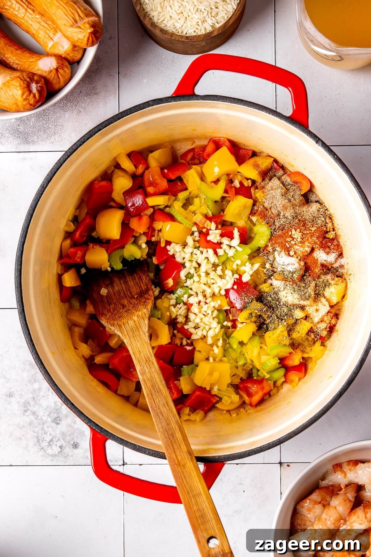 Adding and blooming spices to sautéed vegetables for Cajun dish
