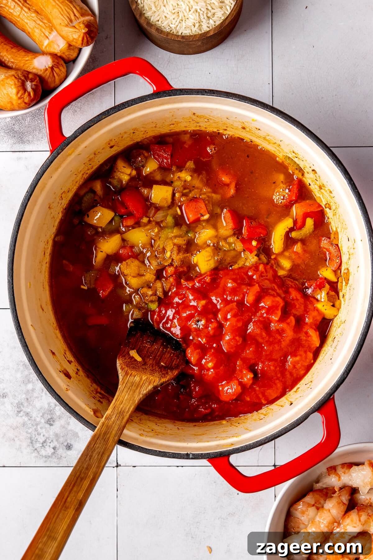 Rice and sausage added to simmering chicken broth and fire-roasted tomatoes