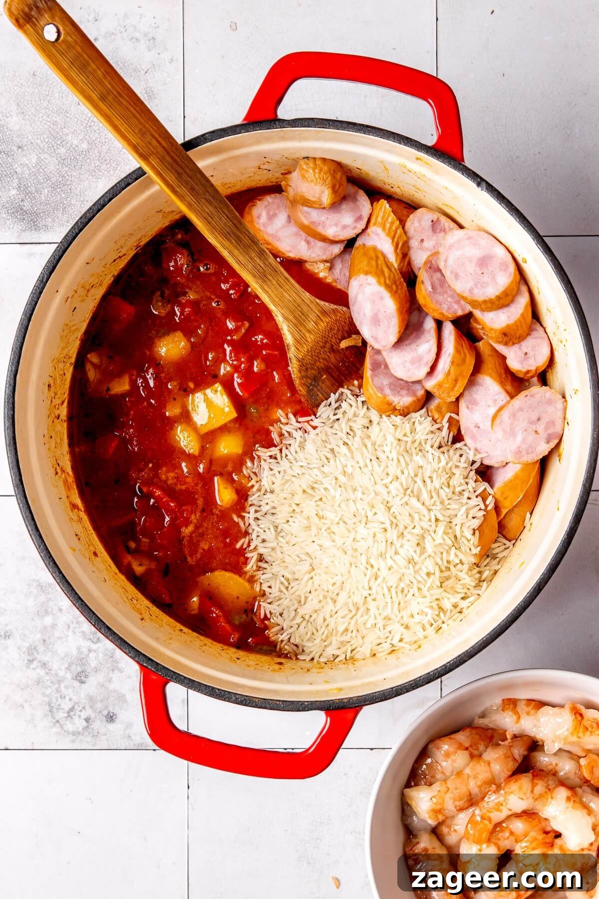 One pot Cajun shrimp and sausage simmering with rice under a lid