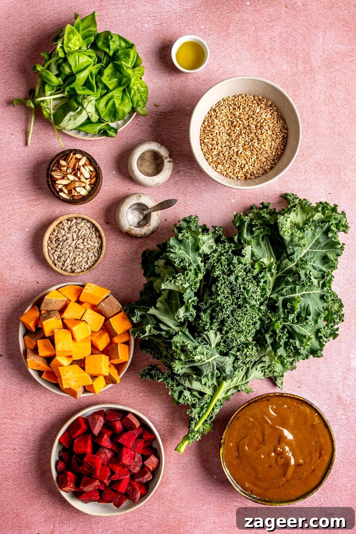 Warm Winter Bounty Salad with Caramelized Shallot Vinaigrette 6 Fresh ingredients laid out for Warm Winter Harvest Salad: sweet potatoes, beets, kale, farro, nuts, and basil