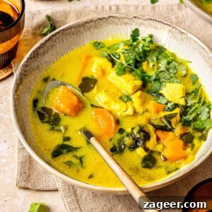 Turmeric Chicken Stew in a bowl with spoon