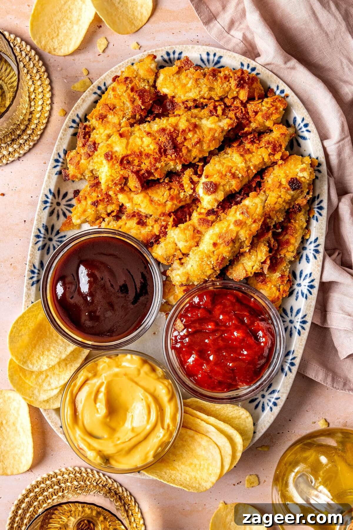 Platter of perfectly baked crispy chicken tenders with sauces