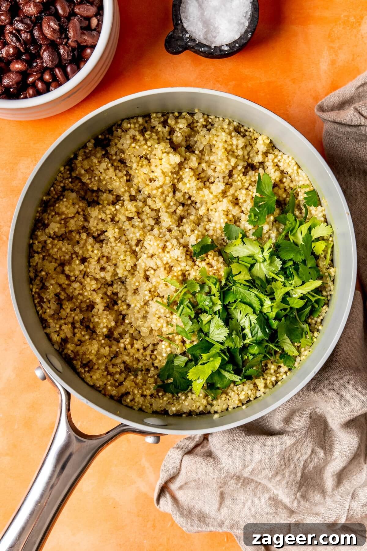 Smoky Shrimp Bowls with Sweet Tropical Salsa 11 Quinoa cooking in a saucepan with bone broth, steaming gently.