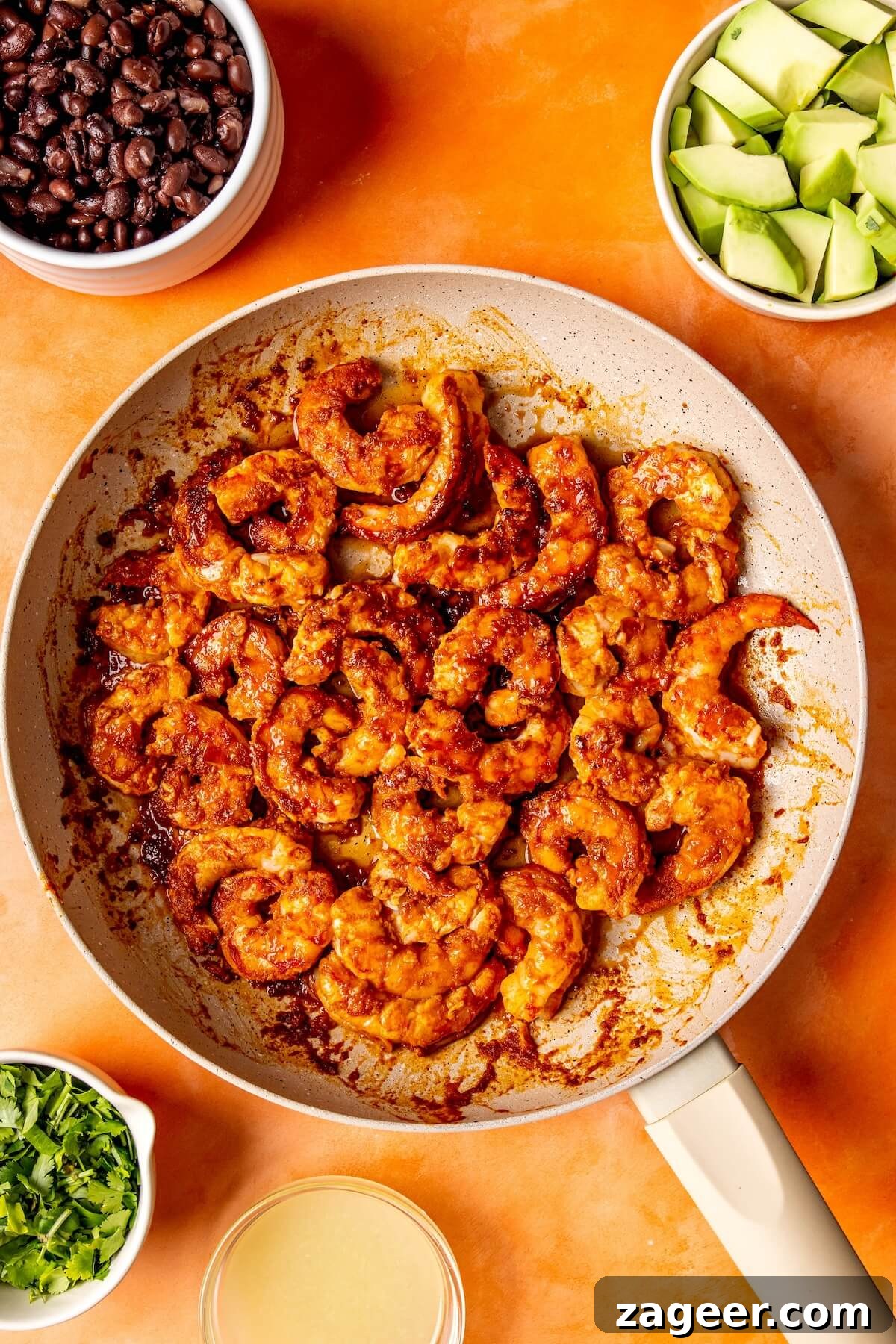 Smoky Shrimp Bowls with Sweet Tropical Salsa 12 Fluffy quinoa being mixed with fresh cilantro and lime juice in a bowl.