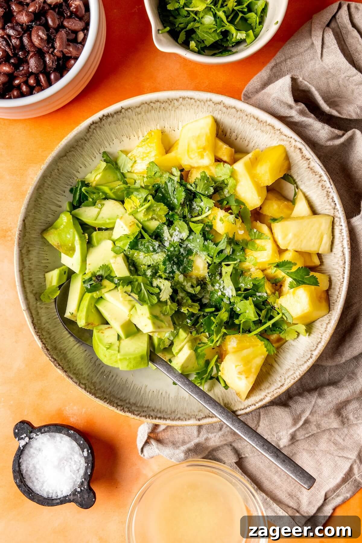 Smoky Shrimp Bowls with Sweet Tropical Salsa 13 A bowl of diced pineapple, avocado, and cilantro, ready to be mixed into salsa.