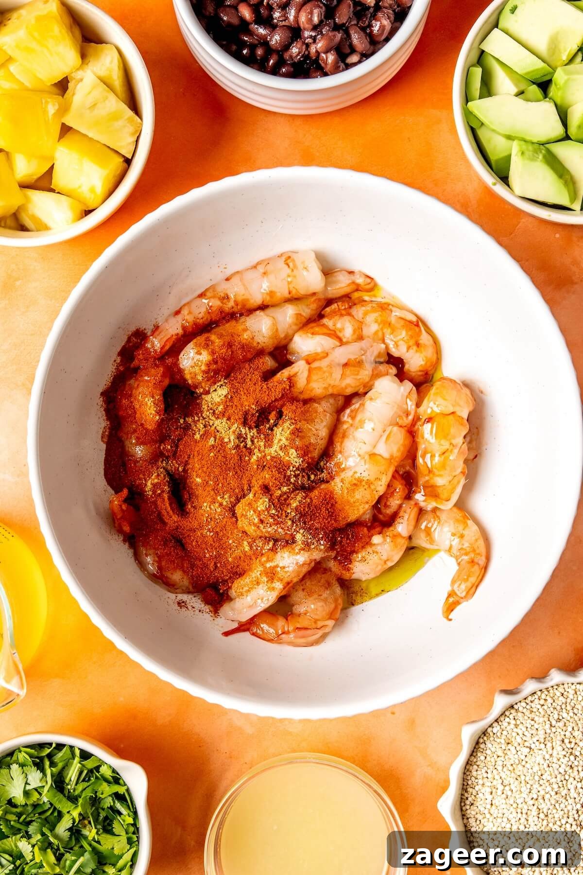 Smoky Shrimp Bowls with Sweet Tropical Salsa 9 A bowl of marinated shrimp, coated in spices and honey, ready to be cooked.