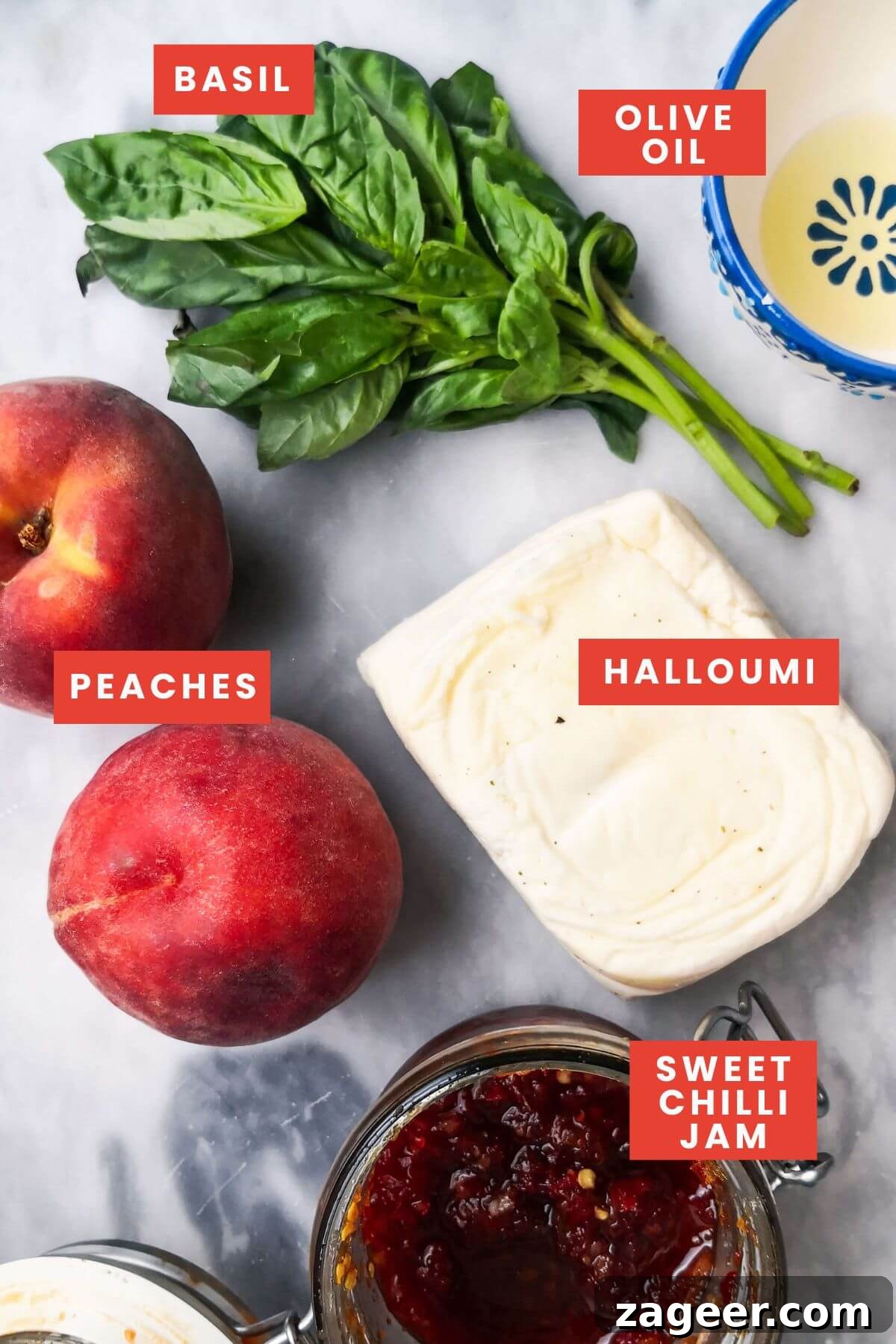 Sweet & Salty Peach Halloumi Salad with Chili Jam 3 All the fresh ingredients for peach and halloumi salad neatly arranged on a sophisticated grey marble background, highlighting the simplicity and quality of each component.
