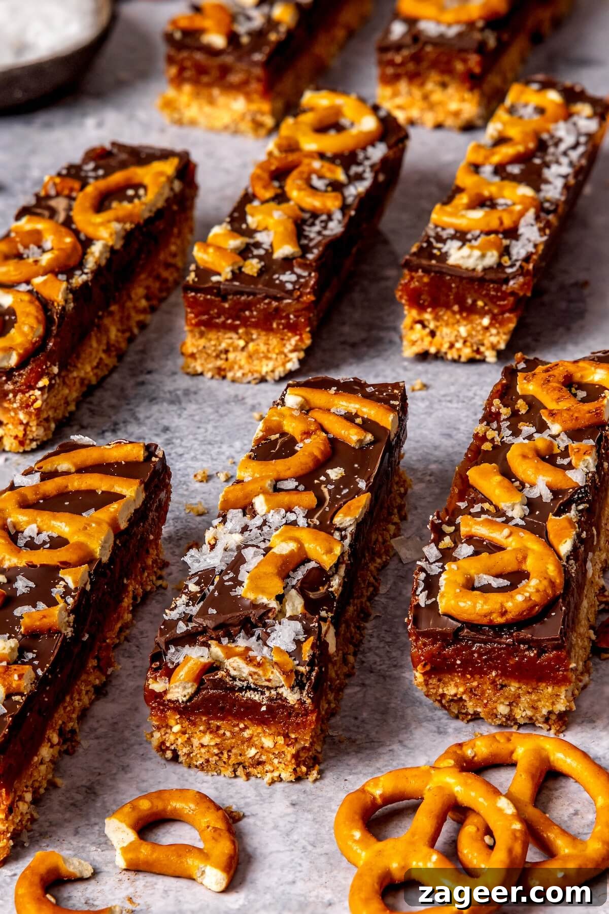 Salty Sweet No Bake Chocolate Peanut Butter Pretzel Bars 2 Delicious No-Bake Chocolate Peanut Butter Pretzel Bars on a serving tray, perfect for sweet and salty cravings.