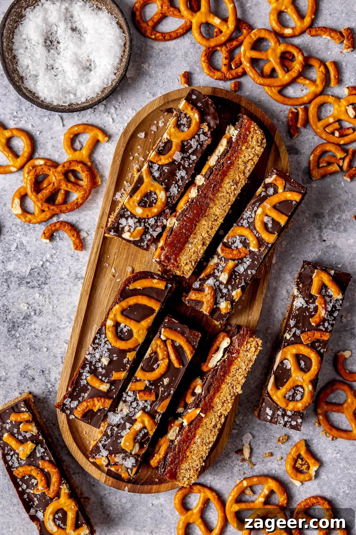 Salty Sweet No Bake Chocolate Peanut Butter Pretzel Bars 3 Layered dessert bars with peanut butter caramel and chocolate, showcasing the delicious texture.