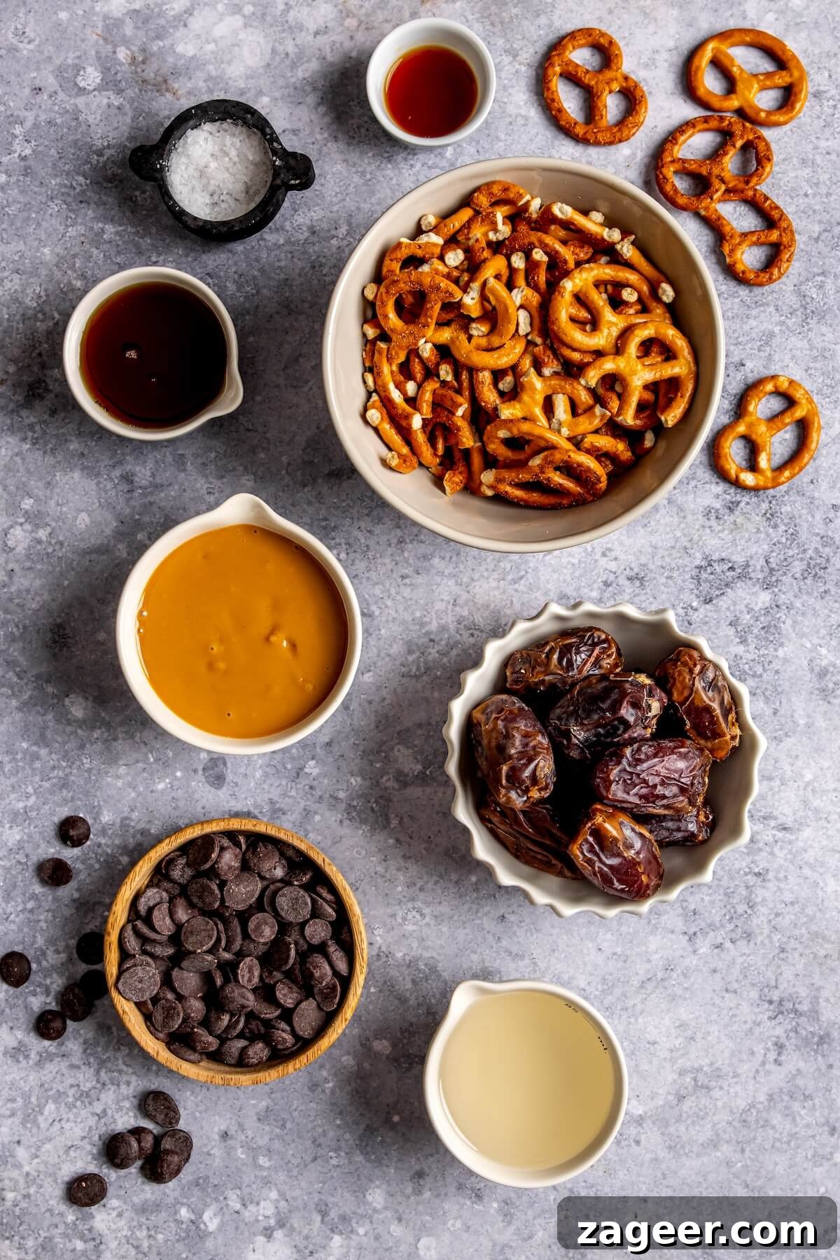 Salty Sweet No Bake Chocolate Peanut Butter Pretzel Bars 6 Arrangement of ingredients for No-Bake Chocolate Peanut Butter Pretzels, including dates, pretzels, and chocolate.