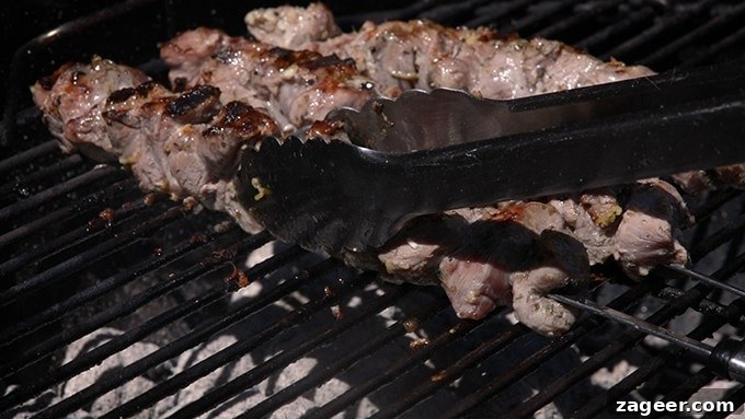Tender Greek Lamb Souvlaki Skewers 3 Delicious Greek Lamb Souvlaki Kebabs cooking on a hot barbecue grill, showing beautiful char marks.