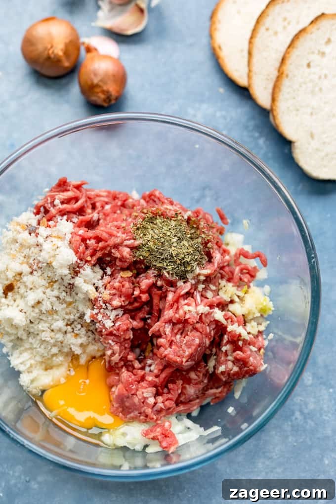 Smoky Meatball Pasta Bake Even The Pickiest Eaters Will Adore 2 Mixture for meatballs in a bowl on a blue background