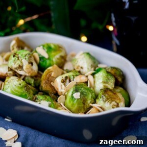 Roasted Honey Balsamic Sprouts with Toasted Almonds 2 Close up image of roasted sprouts with honey, balsamic and almonds in a grey and white dish.