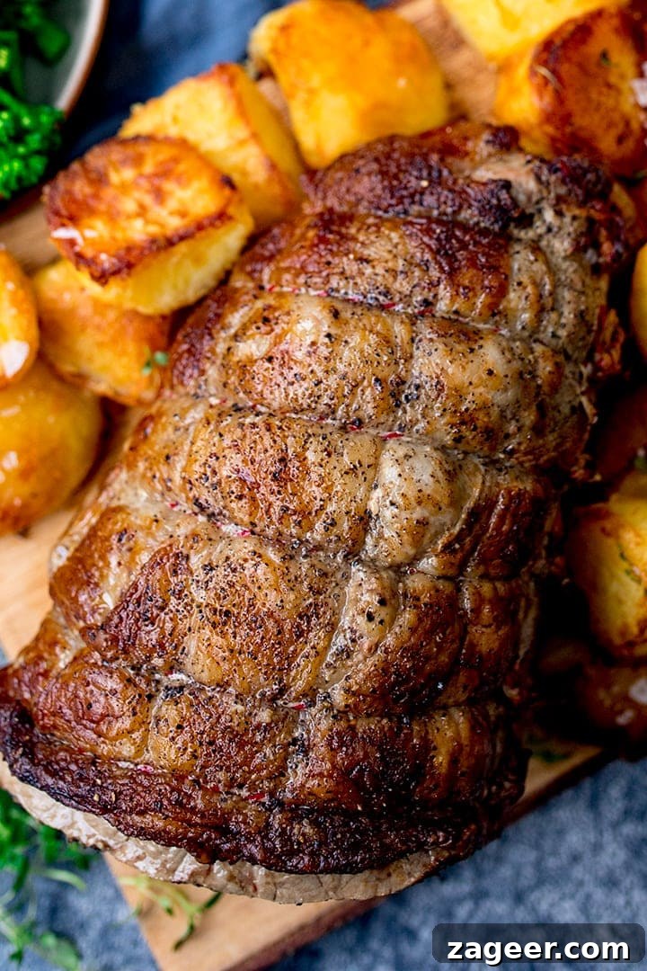 Perfect Roast Beef Every Time: Your Planning Blueprint 4 Overhead view of a large joint of roast beef on a wooden board, surrounded by golden roast potatoes, hinting at a satisfying meal.