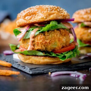 Cheesy Veggie Burger with lettuce on sesame seed bun on blue background
