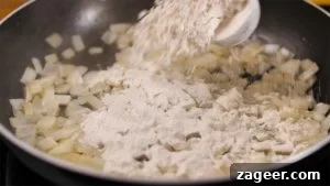 Creamy Chicken Pot Pie Comfort 9 Adding flour to onions in a pan for a soup base