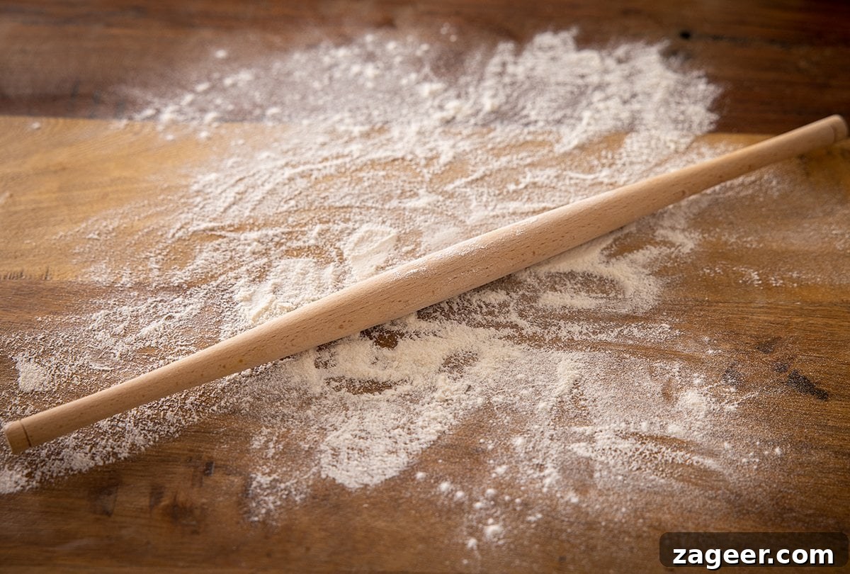 Perfect Homemade Chapati 6 A specialized chapati rolling pin resting on a flour-dusted wooden surface, ready for use.