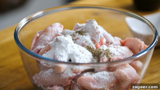 Golden Crisp Oven Buffalo Wings 5 Raw chicken wings in a bowl with baking powder and seasoning