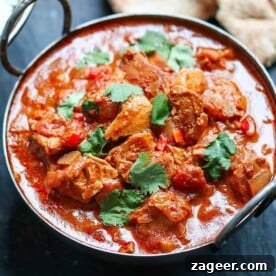 A simple made-from-scratch curry, slow cooked to intensify the heat and flavour, presented in a vibrant bowl with fresh garnishes, ready to be enjoyed.