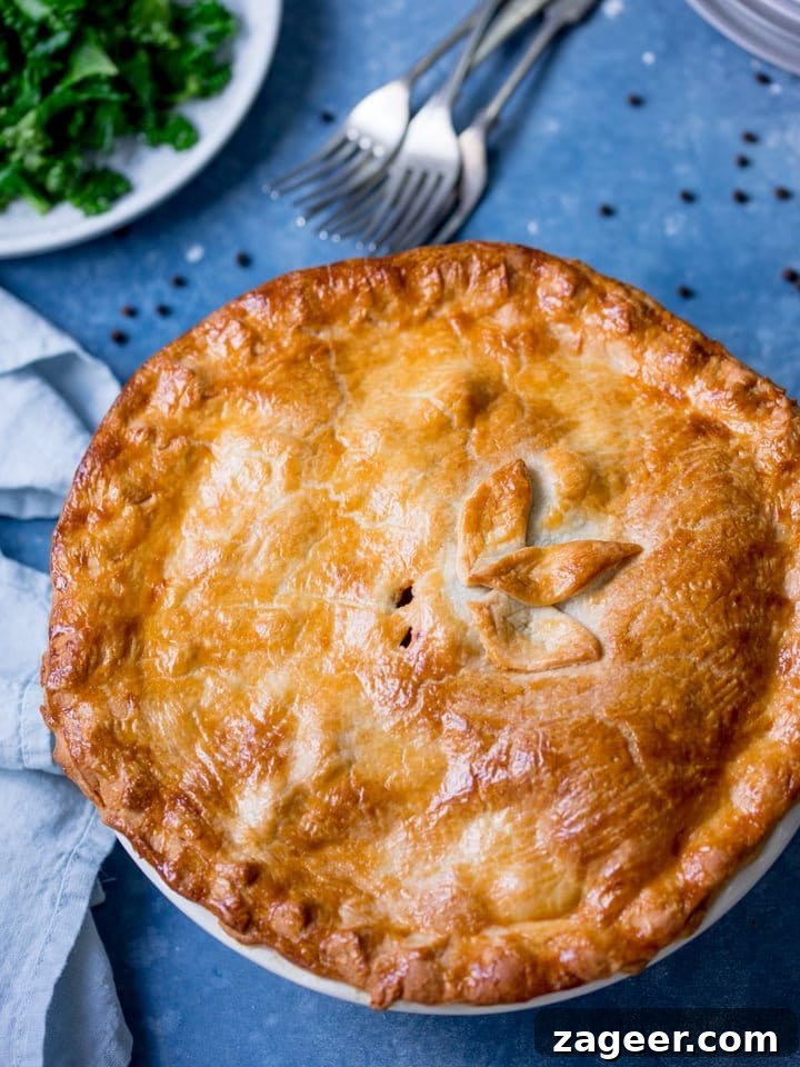 Melt-in-Your-Mouth Slow-Cooked Steak Pie 10 Overhead image of a beautifully baked steak and potato pie, steaming and ready to serve.