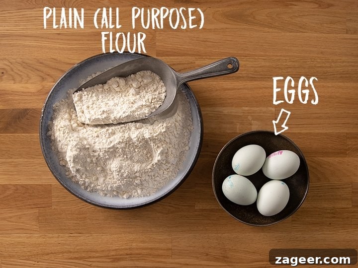 Ingredients for making homemade pasta on a wooden table, featuring flour and eggs.