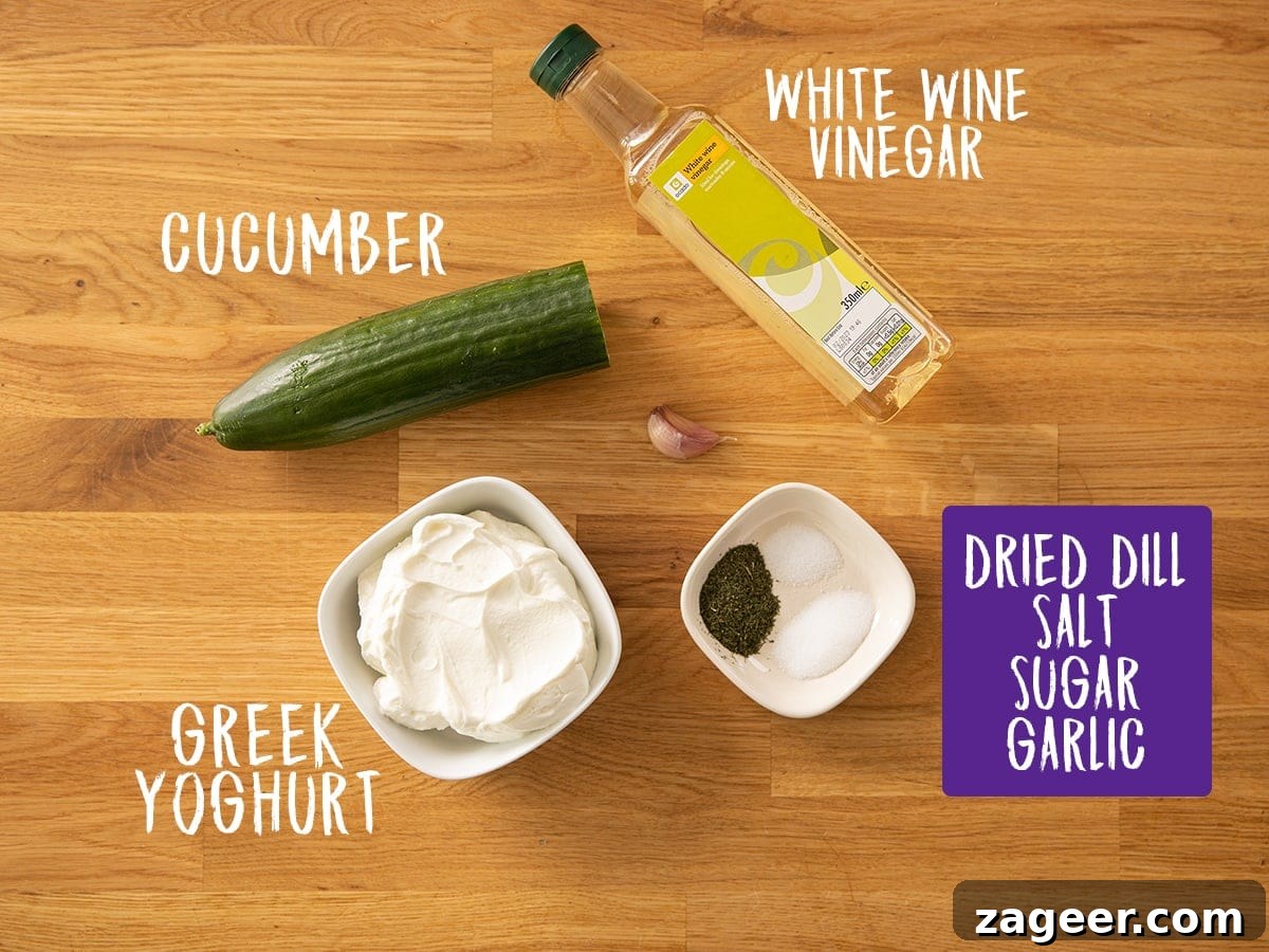 Whip Up Authentic Greek Tzatziki at Home 3 Fresh ingredients for homemade Tzatziki laid out on a rustic wooden table: Greek yogurt, a cucumber, fresh dill, garlic cloves, and white wine vinegar.