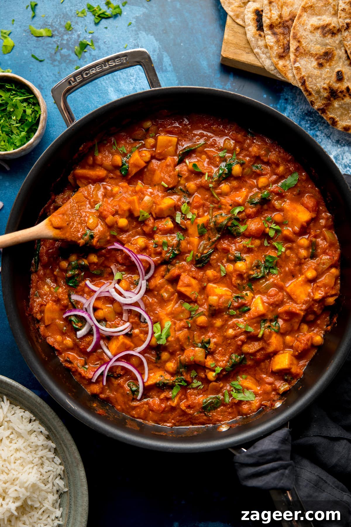 Golden Chickpea Sweet Potato Medley 5 A large pan filled with the simmering chickpea and sweet potato curry, rich and aromatic, ready to be served.