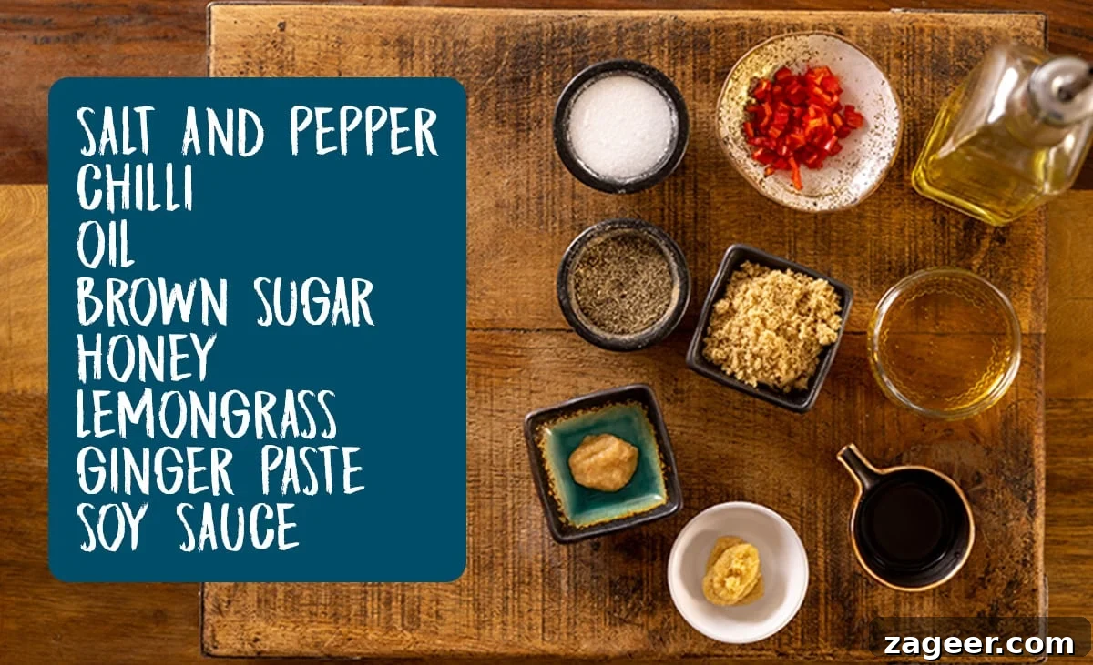 Ingredients for the glaze for sticky Chinese pork belly laid out on a wooden table. There is a list of the ingredients as an overlay in a blue box, including vegetable oil, salt, pepper, ginger, red chili, honey, brown sugar, dark soy sauce, and lemongrass paste.