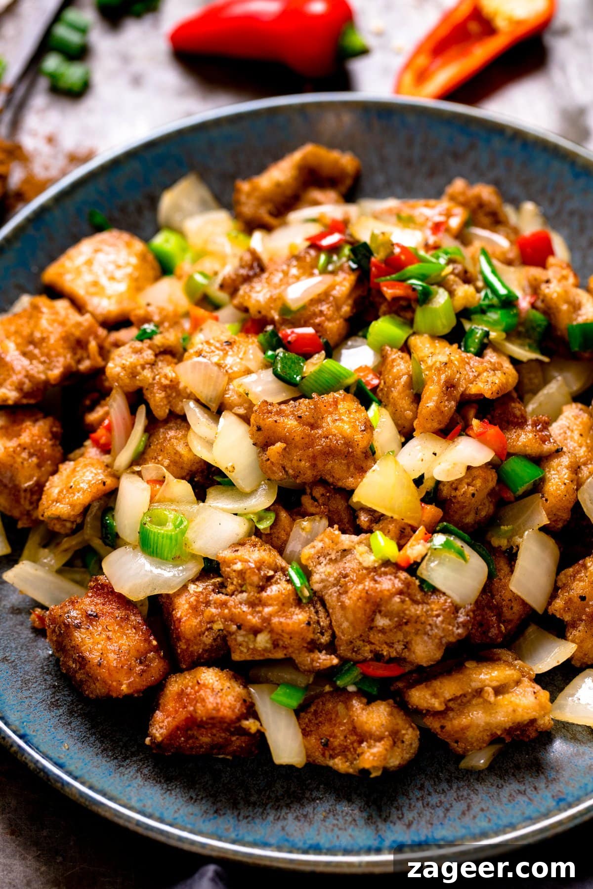Crispy Salt and Pepper Chicken Bites 6 salt and pepper chicken on a plate with ingredients in the background